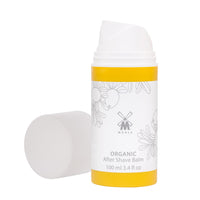 MÜHLE Organic After Shave Balsam, 100 ml geöffnete Flasche mit Deckel daneben, weiß-gelbes Design.